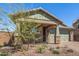 Charming home featuring stone accents, a two-car garage, and a well-maintained front yard at 33395 N 132Nd Dr, Peoria, AZ 85383