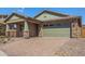 Charming home featuring stone accents, a two-car garage, and a brick paved driveway at 33395 N 132Nd Dr, Peoria, AZ 85383