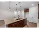 This modern kitchen features a large island, stainless steel appliances, and stylish pendant lighting at 33395 N 132Nd Dr, Peoria, AZ 85383