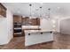 Open concept kitchen featuring a large island with granite countertops and pendant lights at 33395 N 132Nd Dr, Peoria, AZ 85383