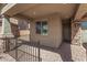 Covered front porch with stone columns and iron railing at 33395 N 132Nd Dr, Peoria, AZ 85383