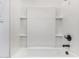 Updated white shower with dark fixtures and built in storage at 33395 N 132Nd Dr, Peoria, AZ 85383