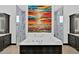 Bathroom with marble tile, soaking tub and colorful art at 3939 W Fox Rd, Laveen, AZ 85339