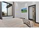 Bright bedroom offers a sleek design with a wall-mounted TV and ensuite bath at 3939 W Fox Rd, Laveen, AZ 85339
