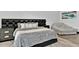 Bedroom with black headboard, gray bedding, and plush armchair at 3939 W Fox Rd, Laveen, AZ 85339