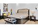 Bedroom with a tufted headboard with adjacent sitting area and elegant decor at 3939 W Fox Rd, Laveen, AZ 85339