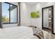 Bright bedroom offers a sleek design with a wall-mounted TV and ensuite bath at 3939 W Fox Rd, Laveen, AZ 85339