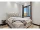 Bright bedroom features a tufted headboard and a large window with scenic mountain views at 3939 W Fox Rd, Laveen, AZ 85339