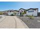 Beautiful white home featuring desert landscaping and a circular driveway leading to the grand entrance at 3939 W Fox Rd, Laveen, AZ 85339