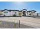 Stunning white home with desert landscaping and a paved circular driveway leading to the grand entrance at 3939 W Fox Rd, Laveen, AZ 85339