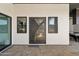 Contemporary home featuring a custom metal front door, windows and desert landscaping at 3939 W Fox Rd, Laveen, AZ 85339