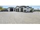 Spacious 3-car garage with dark doors and a large paved driveway, offering ample parking space at 3939 W Fox Rd, Laveen, AZ 85339