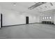 Spacious, well-lit garage with epoxy floors and ample storage space at 3939 W Fox Rd, Laveen, AZ 85339