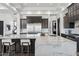 Gourmet kitchen with marble island, stainless steel fridge, and pendant lighting over breakfast bar at 3939 W Fox Rd, Laveen, AZ 85339