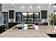 Modern kitchen with a marble island, sleek faucet, and view to the backyard at 3939 W Fox Rd, Laveen, AZ 85339