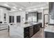 Open kitchen with marble island, dark wood cabinets, and stainless appliances, perfect for modern living at 3939 W Fox Rd, Laveen, AZ 85339