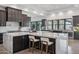 Expansive kitchen with marble countertops, custom cabinetry, and bar seating area at 3939 W Fox Rd, Laveen, AZ 85339