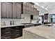 Custom kitchen with stainless appliances, dark cabinets, light countertops, and white backsplash at 3939 W Fox Rd, Laveen, AZ 85339