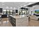 Large kitchen with marble island, dark cabinets, and seamless flow to the living area at 3939 W Fox Rd, Laveen, AZ 85339