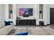 Modern living room featuring sleek built-in cabinets, large screen TV, and a comfortable white sofa at 3939 W Fox Rd, Laveen, AZ 85339