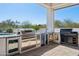Outdoor kitchen with built-in grill, refrigerator, and granite countertops at 3939 W Fox Rd, Laveen, AZ 85339