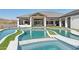 Modern pool and spa with grassy islands and stunning architecture at 3939 W Fox Rd, Laveen, AZ 85339