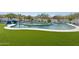 Amazing pool with green turf, a slide, and steps leading to a jacuzzi; excellent for relaxation and recreation at 3939 W Fox Rd, Laveen, AZ 85339