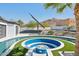 Backyard pool with modern fire pit, solar panel array, and landscaping at 3939 W Fox Rd, Laveen, AZ 85339