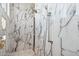 Walk-in shower with marble details and handheld shower head at 3939 W Fox Rd, Laveen, AZ 85339