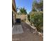 Private backyard featuring gravel landscaping, mature trees and bushes, and a wall for enhanced privacy at 50 W Calle De Arcos --, Tempe, AZ 85284