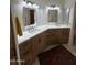 Bright bathroom featuring double vanity sinks with white countertops and ample lighting at 50 W Calle De Arcos --, Tempe, AZ 85284