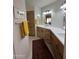 Bathroom featuring double sinks, a red rug and plenty of cabinet space for storage at 50 W Calle De Arcos --, Tempe, AZ 85284