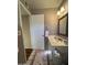 Cozy bathroom featuring a white vanity, decorative mirror, and a charming accent rug at 50 W Calle De Arcos --, Tempe, AZ 85284