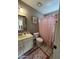 Bathroom features a shower with red curtain, toilet, and sink at 50 W Calle De Arcos --, Tempe, AZ 85284