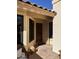 Inviting entryway featuring tiled flooring, a wooden front door, and a cozy seating area at 50 W Calle De Arcos --, Tempe, AZ 85284
