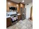 Bright kitchen features stainless steel appliances, tile flooring, and wooden cabinets at 50 W Calle De Arcos --, Tempe, AZ 85284
