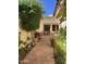 Charming outdoor patio area with brick pavers, lush greenery, and comfortable seating under a pergola at 50 W Calle De Arcos --, Tempe, AZ 85284