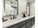 Bathroom featuring dual sinks, modern fixtures, white countertops, and gray cabinets offering lots of storage space at 5129 W Echo Ln, Glendale, AZ 85302