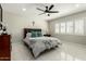 Comfortable bedroom featuring a ceiling fan, shuttered windows, and neutral decor at 5129 W Echo Ln, Glendale, AZ 85302