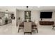 Open-concept dining room featuring a modern table, stylish decor, and seamless flow to the kitchen at 5129 W Echo Ln, Glendale, AZ 85302