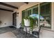 Inviting front porch with stylish seating, decorative plants, and contemporary front door at 5129 W Echo Ln, Glendale, AZ 85302