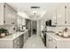 Modern kitchen with white cabinets, stainless steel appliances, and marble countertops at 5129 W Echo Ln, Glendale, AZ 85302