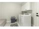 Convenient laundry room with modern washer and dryer, upper cabinets, and durable flooring for easy maintenance at 5129 W Echo Ln, Glendale, AZ 85302