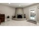 Cozy living room with a statement fireplace and glass door access to outdoor pool at 5129 W Echo Ln, Glendale, AZ 85302