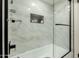Elegant shower with glass door, decorative niche and eye-catching tile that brings a modern touch to the space at 5129 W Echo Ln, Glendale, AZ 85302
