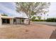 Spacious backyard with a large tree, patio, and privacy fence for outdoor enjoyment at 5607 N 76Th Pl, Scottsdale, AZ 85250