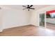 Bedroom has hardwood floors and sliding glass doors leading to the outside at 5607 N 76Th Pl, Scottsdale, AZ 85250