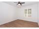 This bedroom features new hardwood floors, a ceiling fan, and bright, shuttered windows at 5607 N 76Th Pl, Scottsdale, AZ 85250