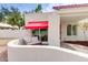 The front courtyard has a seating area with a red awning at 5607 N 76Th Pl, Scottsdale, AZ 85250