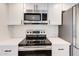 Close-up of the modern stainless steel microwave and electric range cooktop at 5607 N 76Th Pl, Scottsdale, AZ 85250